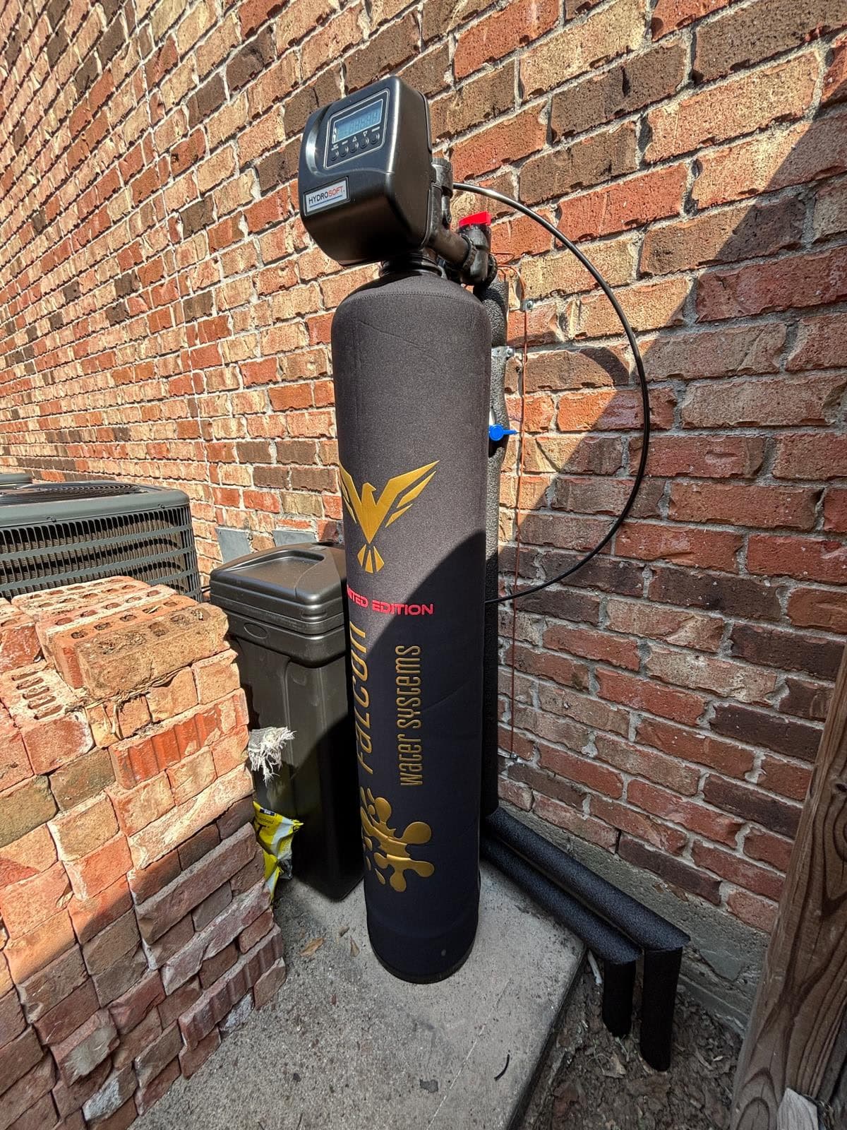Limited Edition black and gold tank standing against a brick exterior wall